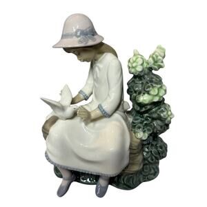 Nao by Lladro porcelain titled "Girl Sitting on Bench Feeding Doves" model #0383